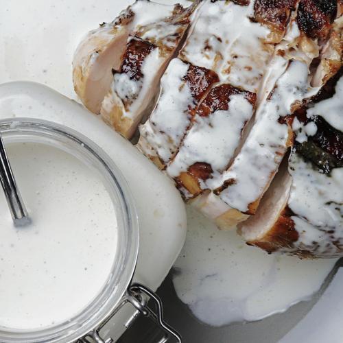 BBQ chicken breast with Alabama white BBQ sauce poured on top.