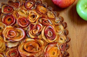 Apple Rose Tart pairs a crunchy, toasted pecan crust with rich apple butter cheesecake covered in roses made from sliced apples. Get your camera ready!