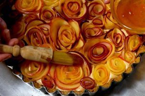 Apple Rose Tart pairs a crunchy, toasted pecan crust with rich apple butter cheesecake covered in roses made from sliced apples. Get your camera ready!