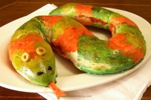 A delightfully creepy treat for Halloween! An easy pepperoni and cheese filled calzone shaped like a snake. Ready to slither onto your plate!