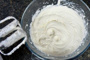 Beat whipping cream with powdered sugar
