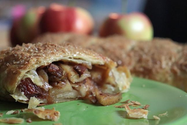 Delicious apple strudel with big chunks of cooked apple in a sweet sauce with a flakey crust.