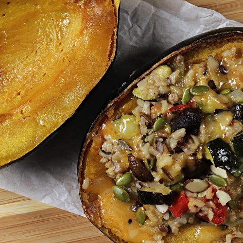 Delicious oven baked acorn squash stuffed with rice, sausage, veggies and melted cheese on top. Divine!