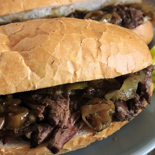 A juicy sandwich of shredded Mississippi Pot roast on a soft sandwich roll. Spicy pepperoncini peppers on the side. Scrumptious!