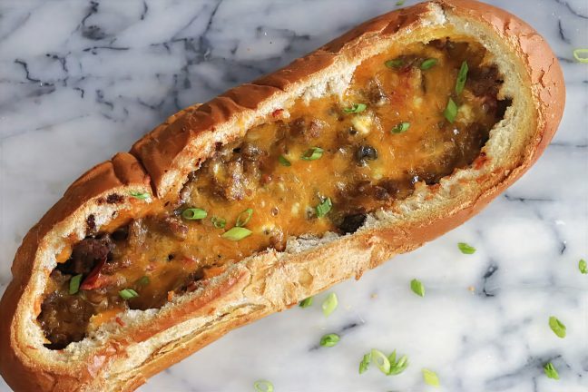 Breakfast Boats made with French bread filled with sausage, cheese, and eggs – a hearty, budget-friendly brunch recipe.