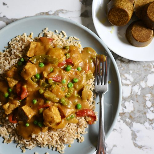 A plate of delicious, curried chicken over rice with loads of veggies. There are also disks of curry roux, used to make this curry easily and inexpensively. The recipe is in the post.